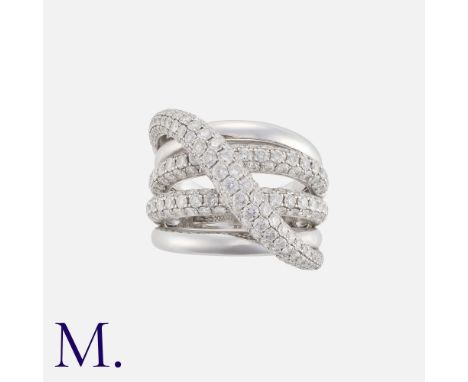 A Diamond Dress Ring in 18k white gold, comprising five bands, of crossover design, three of which set with round cut diamond