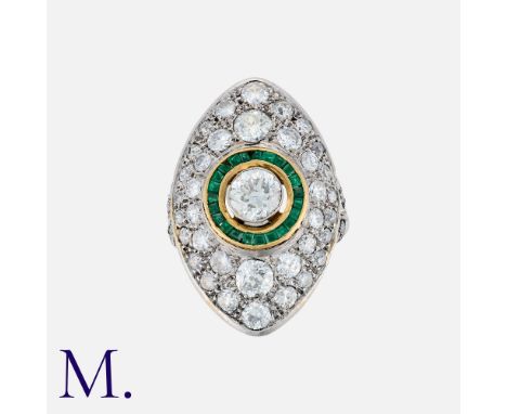 An Art Deco Emerald and Diamond Ring, set with a  round cut diamond to the centre, calibrated emeralds in surround with furth