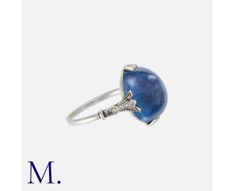 An Art Deco Sapphire and Diamond Ring in platinum, set with a cabochon sapphire weighing approximately 14.0ct with diamond-ac