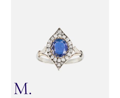 A Sapphire and Diamond Ring in 18K white gold, set with a cushion cut sapphire to the centre with old cut diamonds.Size: M1/2