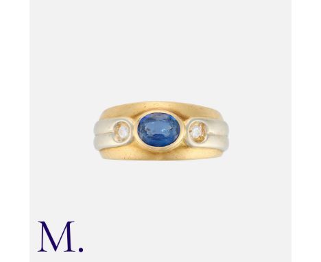 MELLERIO. A Sapphire and Diamond Ring in 18K yellow and white gold, set with an oval-cut sapphire to the centre with two roun