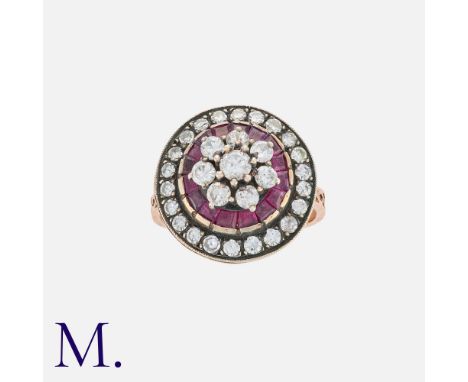 A Ruby and Diamond Ring in rose gold, set with calibre rubies and round cut diamonds weighing approximately 1.2ct.  Rose gold