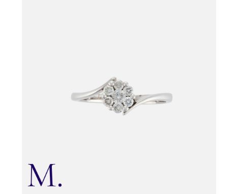 NO RESERVE. A Diamond Cluster ring in 9k white gold, the central cluster of seven round cut diamonds to a twisted band. Stamp