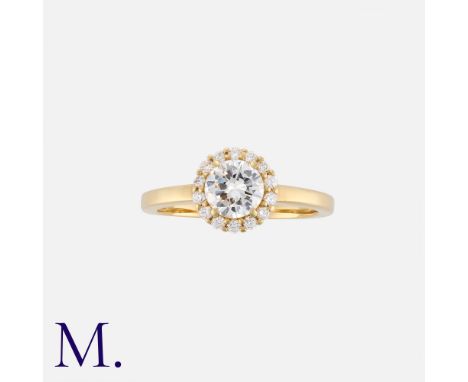 A Diamond Engagement Ring in 18k yellow gold, set with a principal round brilliant cut diamond of approximately 0.75cts. with