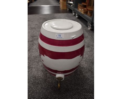 A large vintage ceramic keg with tap.