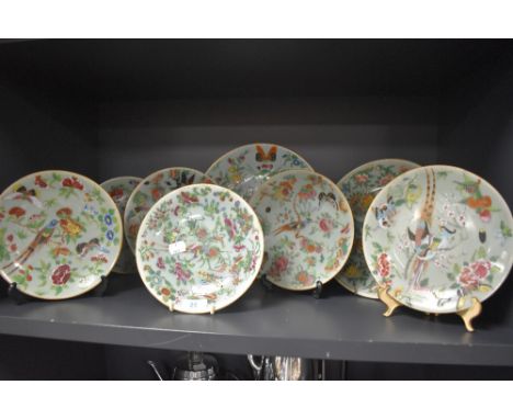 A collection of eight hard paste Chinese plates in Cantonese designs painted with butterfly bird and floral designs
All in go