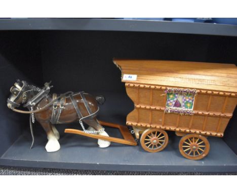 A vintage ceramic horse pulling wooden Romany caravan.