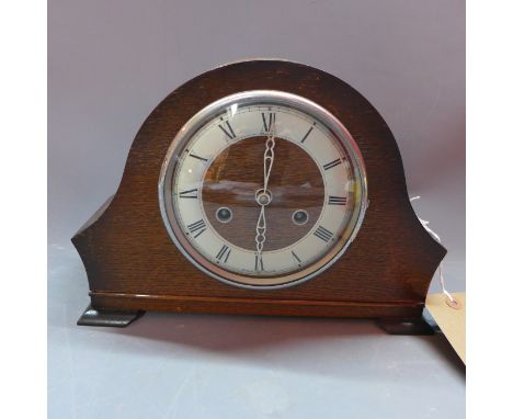 A mid 20th century Benting oak mantle clock, eight day movement, the silvered chapter ring with Roman numerals, raised on bra