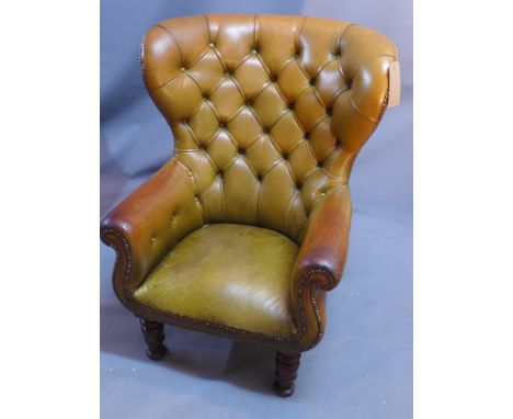 A 19th century green leather spoon wingback armchair with button back upholstery raised on turned legs. 