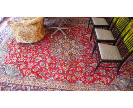 A large fine isfahan carpet with central floral medallion on a red field contained by various floral borders. 419x302cm 