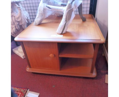 A mid 20th Century teak coffee table with two drawers, one cupboard door and shelf space raised on castors, H:46cm W:76cm D:7