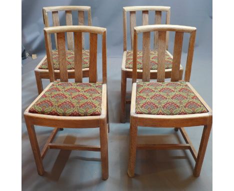 A set of four Heals limed oak dining chairs with william morris style upholstered seats and each set with original Heals butt