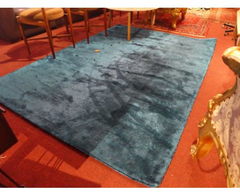 A contemporary hand woven carpet on a blue field. 231x161cm 