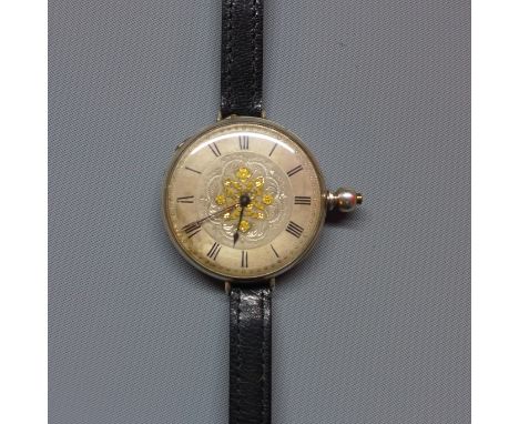A late 19th century silver pocket watch converted to a wristwatch, the silvered Roman dial with floral engraving and parcel g