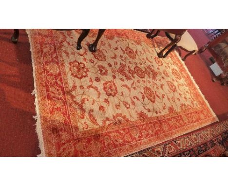 A Zeigler style carpet with central floral design on a beige ground contained by borders. 280x200 