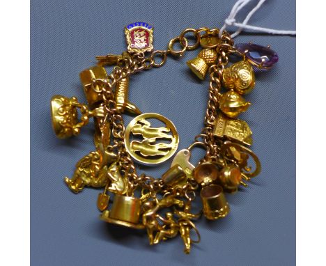 A 9ct yellow gold charm bracelet, with 9ct yellow gold and yellow metal charms, including a rabbit in a hat, red riding hood 