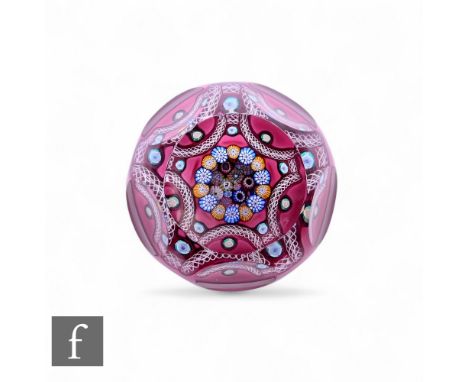 John Deacons - A contemporary glass paperweight, internally decorated with a porthole revealing a central closepack of multic