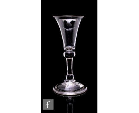 An 18th Century gin glass circa 1730, the slender bell bowl above a balustroid stem with shoulder and basal knop, raised to a