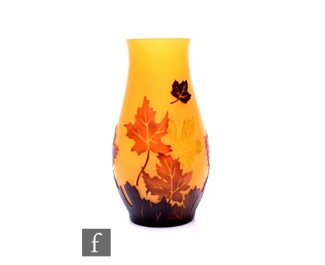 Follower of Emile Galle - A cameo glass vase, of baluster form, tonal brown and green over orange and cut with falling maple 
