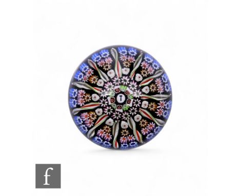Perthshire - A later 20th Century type glass paperweight, of domed form, internally decorated with a cartwheel design compris