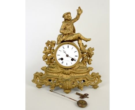 Gilt metal mantel clock surmounted with the figure of a seated man,  30cm x 28cm  