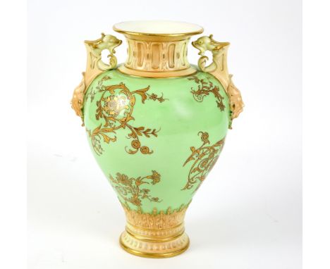 19th century Royal Worcester twin-handled vase of baluster form, the pale green ground with gilt decoration of flowers and fo