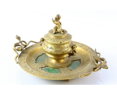 Victorian gilt-metal and green hardstone inkwell, decorated with snake handles, the cover surmounted by a cherub, 23 cm wide