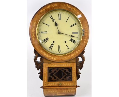 American 8 day drop dial wall clock, 31 cm dial with Roman numerals. Case with carved oak ears, inlaid with floral decoration