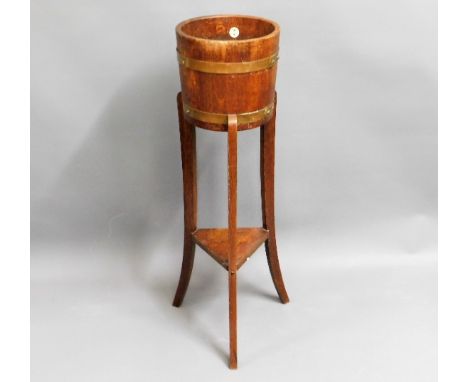 A brass bound R. A. Lister &amp; Co. oak plant pot, 35.75in tall 