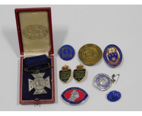 A hallmarked silver &amp; enamel nurses badge, a NHCIF badge, National Hospital Services Reserve badges &amp; other badges/me