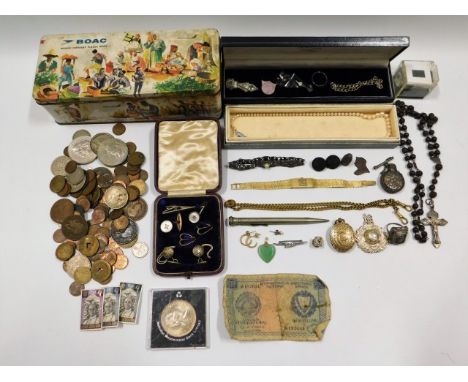 A BOAC tin with mostly costume jewellery contents including a 19thC. yellow metal locket, a small jade heart shaped pendant, 