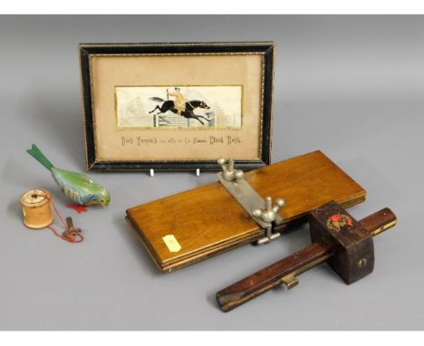 A framed Stevengraph, "Dick Turpin's last ride on bonnie Black Bess", a small tinplate clockwork bird, a flower press &amp; a