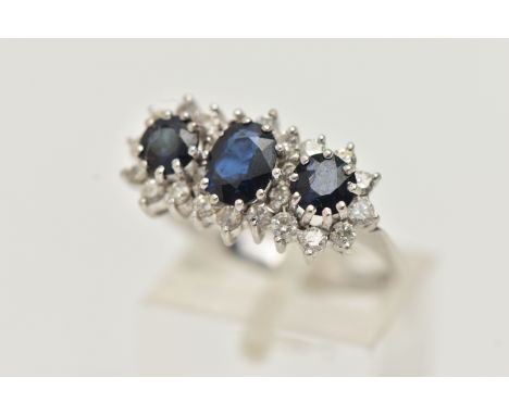 AN 18CT WHITE GOLD SAPPHIRE AND DIAMOND RING, designed as a central oval sapphire flanked by circular sapphires all within br