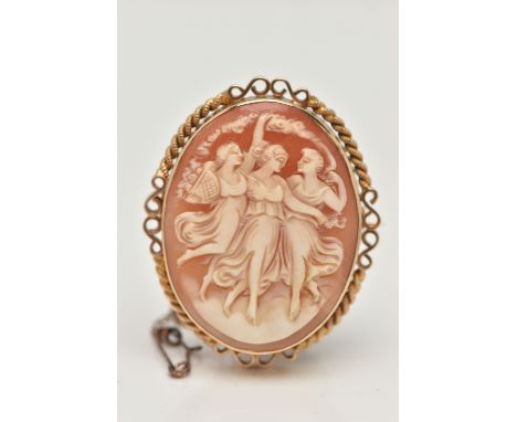 A 9CT GOLD CAMEO BROOCH, of an oval form, carved shell cameo depicting the Three Graces, collet set within a rope twist and s