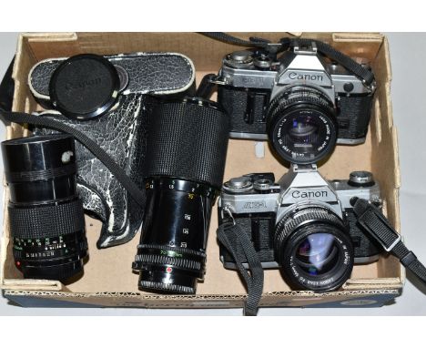 VINTAGE CANON PHOTOGRAPHIC EQUIPMENT, comprising two Canon AE-1 35mm SLR camera bodies, a Canon 50mm f1.4 lens, 50mm f1.8 len
