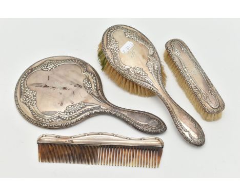 AN EARLY 2OTH CENTURY SILVER DRESSING TABLE SET AND A COMB, the set including a mirror and two brushes embossed with floral d