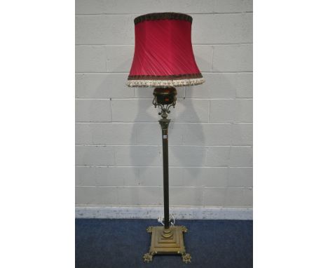 A HEAVY HINKS BRASS STANDARD LAMP, converted from a paraffin lamp, with a Corinthian pillar, on a square stepped base and fou