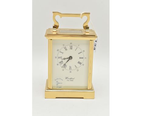 A BRASS 'WOODFORD' CARRIAGE CLOCK, white dial signed 'Woodford Est.1860', Roman numerals, blue steel hands, approximate heigh