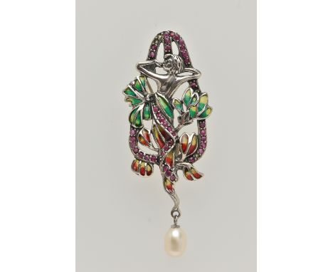A WHITE METAL PLIQUE A JOUR BROOCH, art nouveau style, displaying a lady within flowers, set within a circular cut ruby surro