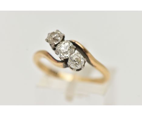 A YELLOW METAL THREE STONE DIAMOND RING, cross over design, set with three old cut diamonds, estimated total diamond weight 0