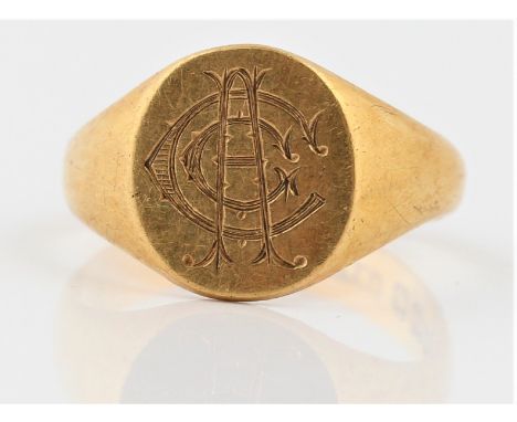 A hallmarked 18ct yellow gold signet ring, the oval head engraved with monogram, ring size S. BOOK A VIEWING TIME SLOT ON OUR