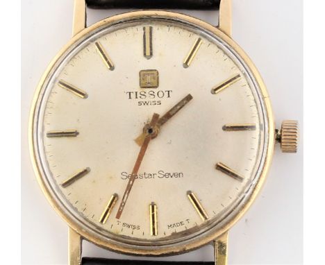 A gents yellow metal Tissot Seastar Seven wrist watch, on a black material strap.