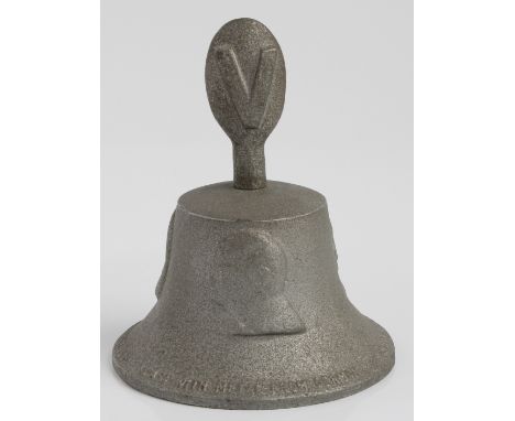 A round bell topped with “V” for victory sign made of metal from a German aircraft shot down over Britain 1939-1945. With rai