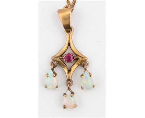 An Edwardian style 9ct yellow gold ruby (possibly synthetic) and opal pendant, the open metalwork design set with a central r