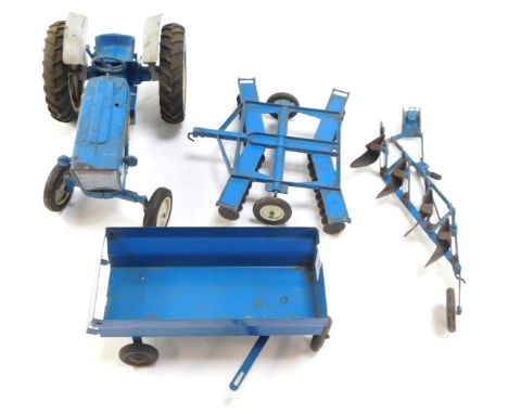 An Ertl Ford 4000 tractor set, with trailer and two ploughs, in blue.
