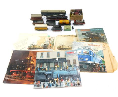 OO gauge railway accessories, comprising a Marklin carriage, Dinky Toys station staff, part wagons, buffers, Marklin magazine