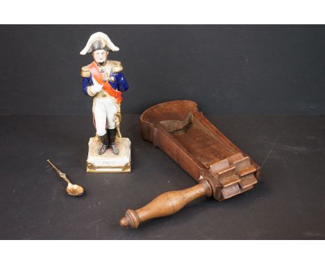 Early to Mid century wooden rattle together with an anointing spoon and a ceramic figure of a soldier in uniform. 