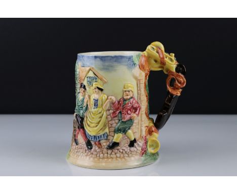 Ceramic Musical Tankard with relief decoration of village folk dancing, with Thorens movement playing the floral dance, 17cms