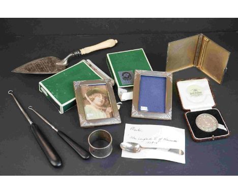 A collection of hallmarked sterling silver items to include Napkin Ring, photograph frames, cigarette case and a trowel toget