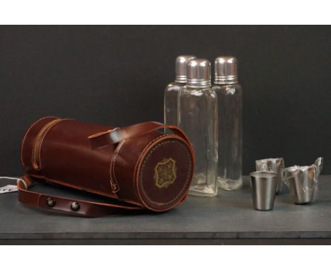 Leather cased triple spirit flask, set with three cups in separate compartments 